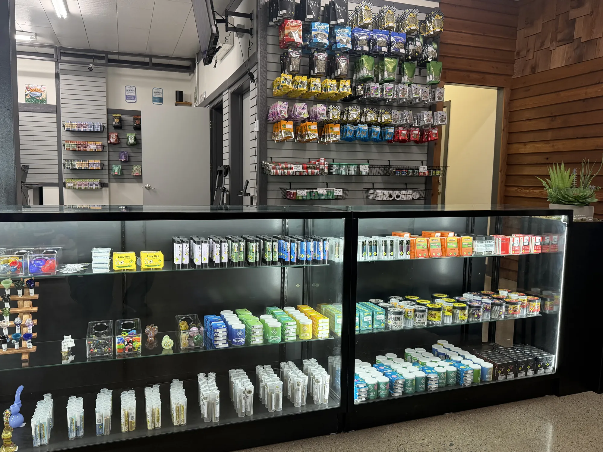 Lit glass display cases of cannabis products at Crystal Leaves in Spokane