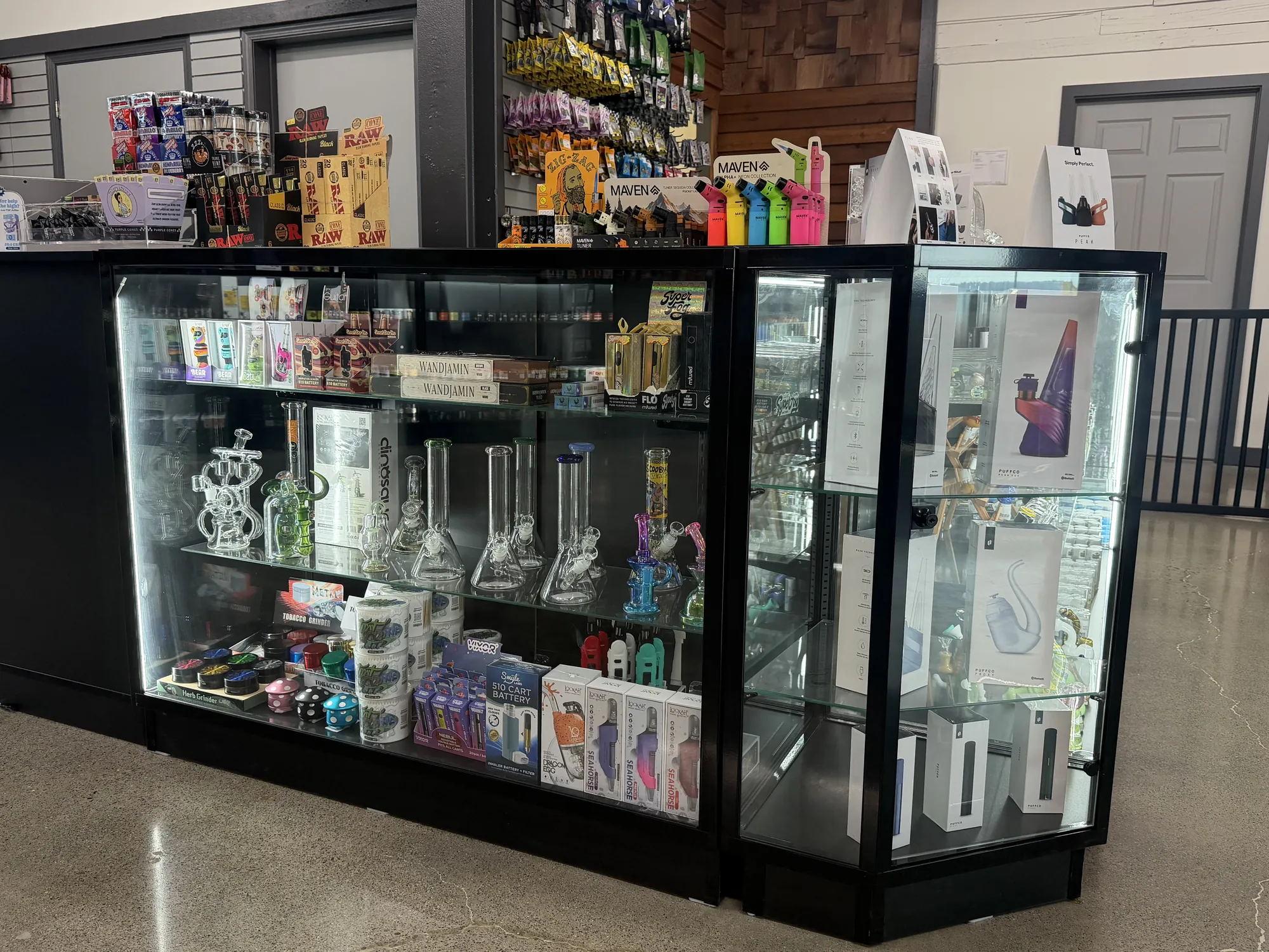 A lit glass case of pipes, bongs and accessories at Crystal Leaves