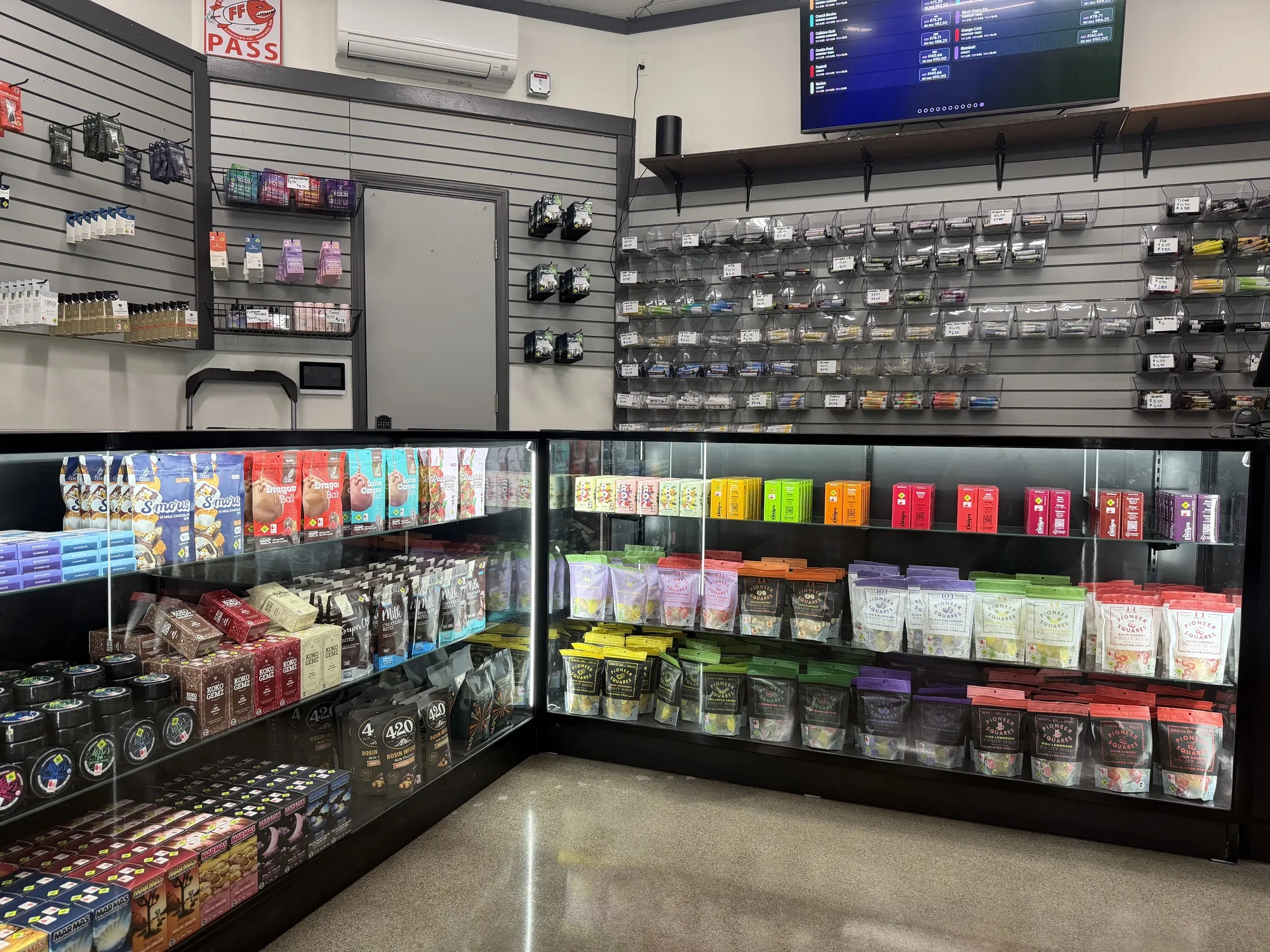 Glass cases stocked with packaged cannabis products at Crystal Leaves